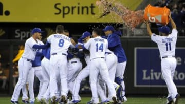 Sep 15, 2014; Kansas City, MO, USA; Kansas City Royals starting pitcher Jeremy Guthrie (11) pours Gatorade on the celebration after center fielder Lorenzo Cain (6) drove in the winning run against the Chicago White Sox in the ninth inning at Kauffman Stadium. Kansas City won the game 4-3. Mandatory Credit: John Rieger-USA TODAY Sports