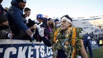 Nov 21, 2015; Provo, UT, USA; Brigham Young Cougars defensive lineman Bronson Kaufusi (90) makes his way around the stadium with his teammates after their 52-10 win against the Fresno State Bulldogs at Lavell Edwards Stadium. Mandatory Credit: Jeff Swinger-USA TODAY Sports