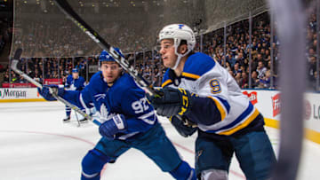 TORONTO, ON - OCTOBER 20: Igor Ozhiganov #92 of the Toronto Maple Leafs battles along the boards against Sammy Blais #9 of the St. Louis Blues during the first period at the Scotiabank Arena on October 20, 2018 in Toronto, Ontario, Canada. (Photo by Kevin Sousa/NHLI via Getty Images)