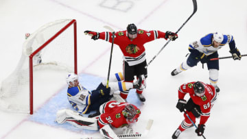 EDMONTON, ALBERTA - JULY 29: Zach Sanford #12 of the St. Louis Blues falls into Malcolm Subban #30 of the Chicago Blackhawks during the third period in an exhibition game prior to the 2020 NHL Stanley Cup Playoffs at Rogers Place on July 29, 2020 in Edmonton, Alberta. (Photo by Jeff Vinnick/Getty Images)