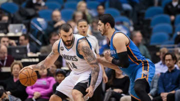 Jan 27, 2016; Minneapolis, MN, USA; Minnesota Timberwolves center Nikola Pekovic (14) dribbles in the second quarter against the Oklahoma City Thunder center Enes Kanter (11) at Target Center. Mandatory Credit: Brad Rempel-USA TODAY Sports