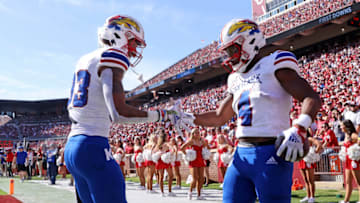 Oct 15, 2022; Norman, Oklahoma, USA; Kansas Jayhawks running back Devin Neal (4) celebrates with Kansas Jayhawks wide receiver Quentin Skinner (83) after scoring a touchdown during the first half against the Oklahoma Sooners at Gaylord Family-Oklahoma Memorial Stadium. Mandatory Credit: Kevin Jairaj-USA TODAY Sports