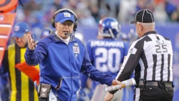 Jan 3, 2016; East Rutherford, NJ, USA; New York Giants head coach Tom Coughlin (L) questions a call with side judge Bob Waggoner (25) during the second half against the Philadelphia Eagles and discusses at MetLife Stadium. The Eagles won 35-30. Mandatory Credit: Jim O