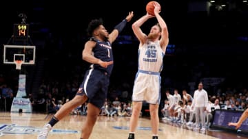 Mar 10, 2022; Brooklyn, NY, USA; North Carolina Tar Heels forward Brady Manek (45) shoots over Virginia Cavaliers forward Jayden Gardner (1) during the first half at Barclays Center. Mandatory Credit: Brad Penner-USA TODAY Sports