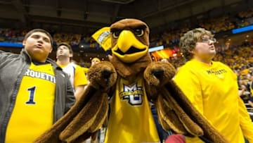 Dec 6, 2014; Milwaukee, WI, USA; The Marquette Golden Eagles mascot cheers with fans prior to the game against the Wisconsin Badgers at BMO Harris Bradley Center. Wisconsin won 49-38. Mandatory Credit: Jeff Hanisch-USA TODAY Sports