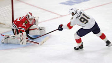 CHICAGO, ILLINOIS - MARCH 25: Kevin Lankinen #32 of the Chicago Blackhawks stops a shot by Anthony Duclair #91 of the Florida Panthers at the United Center on March 25, 2021 in Chicago, Illinois. (Photo by Jonathan Daniel/Getty Images)