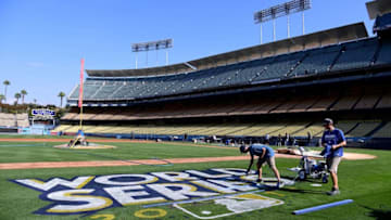 LOS ANGELES, CA - OCTOBER 20: (L-R) Los Angeles Dodgers grounds crew Jordan Lorenz and Justin Patenaude paint the World Series logo on to the field in preparation for game one and two at Dodger Stadium on October 20, 2017 in Los Angeles, California. (Photo by Harry How/Getty Images)