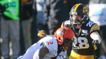 IOWA CITY, IOWA- NOVEMBER 23: Defensive back Jack Koerner #28 of the Iowa Hawkeyes makes a tackle during the second half on running back Reggie Corbin #2 of the Illinois Fighting Illini on November 23, 2019 at Kinnick Stadium in Iowa City, Iowa. (Photo by Matthew Holst/Getty Images)