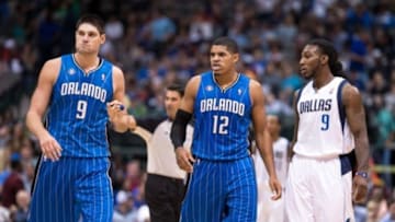 Oct 14, 2013; Dallas, TX, USA; Orlando Magic center Nikola Vucevic (9) and small forward Tobias Harris (12) and Dallas Mavericks small forward Jae Crowder (9) wait for play to resume during the game at the American Airlines Center. The Magic defeated the Mavericks 102-94. Mandatory Credit: Jerome Miron-USA TODAY Sports