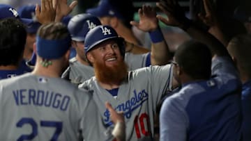 DENVER, COLORADO - JULY 30: Justin Turner #10 of the Los Angeles Dodgers celebrates in the dugout after hitting a 2 RBI home run in the fourth inning against the Colorado Rockies at Coors Field on July 30, 2019 in Denver, Colorado. (Photo by Matthew Stockman/Getty Images)