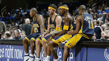CLEVELAND - DECEMBER 27: Ron Artest #23, Brad Miller #52, Al Harrington #3 and Jamaal Tinsley #11 of the Indiana Pacers sit on the scorer's table during the NBA game against the Cleveland Cavaliers at Gund Arena on December 27, 2002 in Cleveland, Ohio. The Pacers won 113-89. =(Photo by: David Liam Kyle/NBAE/Getty Images)