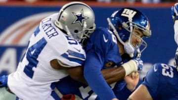 Nov 24, 2013; East Rutherford, NJ, USA; New York Giants quarterback Eli Manning (10) is hit by Dallas Cowboys outside linebacker Bruce Carter (54) during the game at MetLife Stadium. Mandatory Credit: Robert Deutsch-USA TODAY Sports