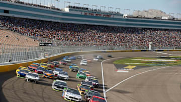 LAS VEGAS, NEVADA - SEPTEMBER 15: Clint Bowyer, driver of the #14 Toco Warranty Ford, and Daniel Suarez, driver of the #41 Haas Automation Ford, lead the field to start the Monster Energy NASCAR Cup Series South Point 400 at Las Vegas Motor Speedway on September 15, 2019 in Las Vegas, Nevada. (Photo by Jonathan Ferrey/Getty Images)