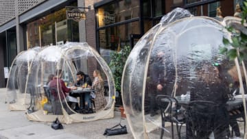 NEW YORK, NEW YORK - OCTOBER 25: People dine outdoors in plastic bubbles at Suprema Provisions on October 25, 2020 in New York City. Restaurants are finding ways to extend the outdoor dining season as long as possible by adding plastic bubbles, outdoor heaters and plexiglass tents. The pandemic continues to burden restaurants and bars as businesses struggle to thrive with evolving government restrictions and social distancing plans which impact keeping businesses open yet challenge profitability. (Photo by Alexi Rosenfeld/Getty Images)