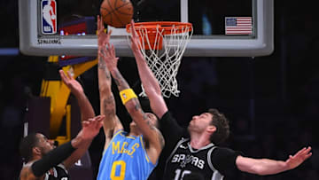 LOS ANGELES, CA - APRIL 04: Kyle Kuzma #0 of the Los Angeles Lakers makes a shot between the defense of LaMarcus Aldridge #12 and Pau Gasol #16 of the San Antonio Spurs in the second half of the game at Staples Center on April 4, 2018 in Los Angeles, California. NOTE TO USER: User expressly acknowledges and agrees that, by downloading and or using this photograph, User is consenting to the terms and conditions of the Getty Images License Agreement. (Photo by Jayne Kamin-Oncea/Getty Images)