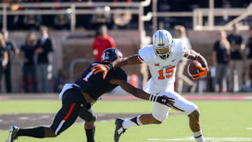 LUBBOCK, TX - OCTOBER 31: Chris Lacy #15 of the Oklahoma State Cowboys runs around Nigel Bethel #1 of the Texas Tech Red Raiders during the second quarter on October 31, 2015 at Jones AT&T Stadium in Lubbock, Texas. Oklahoma State defeated Texas Tech 70-53. (Photo by John Weast/Getty Images)