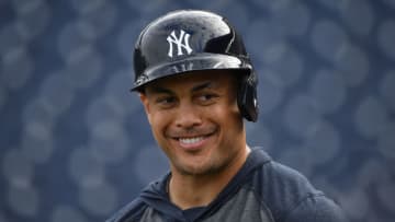 TAMPA, FLORIDA - FEBRUARY 24: Giancarlo Stanton #27 of the New York Yankees smiling with teammates during batting practice prior to the spring training game against the Pittsburgh Pirates at Steinbrenner Field on February 24, 2020 in Tampa, Florida. (Photo by Mark Brown/Getty Images)
