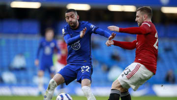 LONDON, ENGLAND - FEBRUARY 28: Luke Shaw of Manchester United is challenged by Hakim Ziyech of Chelsea during the Premier League match between Chelsea and Manchester United at Stamford Bridge on February 28, 2021 in London, England. Sporting stadiums around the UK remain under strict restrictions due to the Coronavirus Pandemic as Government social distancing laws prohibit fans inside venues resulting in games being played behind closed doors. (Photo by Ian Walton - Pool/Getty Images)