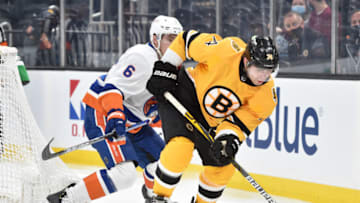 Apr 15, 2021; Boston, Massachusetts, USA; Boston Bruins left wing Jake DeBrusk (74) tries to gain control of the puck in front of New York Islanders defenseman Ryan Pulock (6) during the second period at TD Garden. Mandatory Credit: Bob DeChiara-USA TODAY Sports