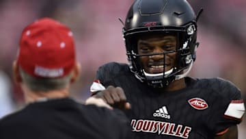 Oct 14, 2016; Louisville, KY, USA; Louisville Cardinals quarterback Lamar Jackson (8) fist bumps head coach Bobby Petrino before the first quarter against the Duke Blue Devils at Papa John