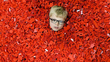GLASGOW, SCOTLAND - JULY 20: Seven year old Ben MacDonald, submerses himself in Lego during Bricklive at the Scottish Exhibition and Conference Center on July 20, 2017 in Glasgow, Scotland. Europe's largest Lego event was debuting in the city for the first time, treating fans to creations from the world's best builders. (Photo by Jeff J Mitchell/Getty Images)