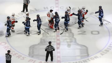 EDMONTON, ALBERTA - AUGUST 06: The Calgary Flames and Winnipeg Jets shake hands after the Flames 3-0 win in Game Four of the Western Conference Qualification Round prior to the 2020 NHL Stanley Cup Playoffs at Rogers Place on August 06, 2020 in Edmonton, Alberta. (Photo by Jeff Vinnick/Getty Images)