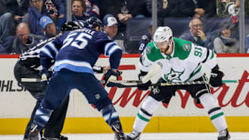 WINNIPEG, MB - NOVEMBER 2: Mark Scheifele #55 of the Winnipeg Jets and Tyler Seguin #91 of the Dallas Stars get set to take a first period face-off at the Bell MTS Place on November 2, 2017 in Winnipeg, Manitoba, Canada. (Photo by Jonathan Kozub/NHLI via Getty Images)