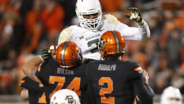 Nov 21, 2015; Stillwater, OK, USA; Baylor Bears defensive end Shawn Oakman (2) attempts to block a pass of Oklahoma State Cowboys quarterback Mason Rudolph (2) in the third quarter at Boone Pickens Stadium. Baylor won 45-35. Mandatory Credit: Tim Heitman-USA TODAY Sports