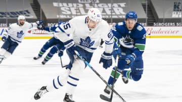 VANCOUVER, BC - APRIL 18: Ilya Mikheyev #65 of the Toronto Maple Leafs drives to the net after getting past Guillaume Brisebois #55 of the Vancouver Canucks during the first period of NHL hockey action at Rogers Arena on April 17, 2021 in Vancouver, Canada. (Photo by Rich Lam/Getty Images)