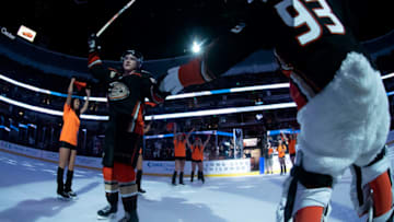 ANAHEIM, CA - MARCH 3: Jakob Silfverberg #33 of the Anaheim Ducks and Wild Wing high-five as Silfverberg is recognized as a star of the game after defeating the Colorado Avalanche 2-1 in the game at Honda Center on March 3, 2019 in Anaheim, California. (Photo by Foster Snell/NHLI via Getty Images)