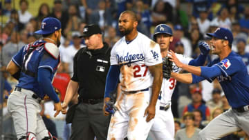 LOS ANGELES, CA - JUNE 13: Cole Hamels #35 of the Texas Rangers and Cody Bellinger #35 of the Los Angeles Dodgers try to hold back Matt Kemp #27 of the Los Angeles Dodgers and Robinson Chirinos #61 of the Texas Rangers as tempers flared after a collision at home plate in the third inning at Dodger Stadium on June 13, 2018 in Los Angeles, California. A benches clearing brawl erupted with Kemp being ejected from the game. (Photo by Jayne Kamin-Oncea/Getty Images)