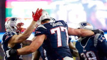FOXBORO, MA - JANUARY 18: Nate Solder #77 of the New England Patriots celebrates with teammates after scoring a touchdown in the third quarter against the Indianapolis Colts of the 2015 AFC Championship Game at Gillette Stadium on January 18, 2015 in Foxboro, Massachusetts. (Photo by Jared Wickerham/Getty Images)