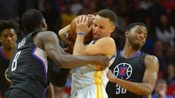 Feb 20, 2016; Los Angeles, CA, USA; Los Angeles Clippers guard C.J. Wilcox (30) and forward Jeff Green (8) foul Golden State Warriors guard Stephen Curry (30) in the second half of the game at Staples Center. Mandatory Credit: Jayne Kamin-Oncea-USA TODAY Sports