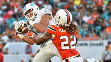 Oct 15, 2016; Miami Gardens, FL, USA; North Carolina Tar Heels wide receiver Mack Hollins (13) makes the catch over the defense of Miami Hurricanes defensive back Sheldrick Redwine (22) during the first half at Hard Rock Stadium. Mandatory Credit: Jasen Vinlove-USA TODAY Sports