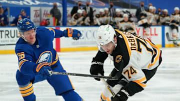 BUFFALO, NY - MARCH 18: Rasmus Dahlin #26 of the Buffalo Sabres defends against Jake DeBrusk #74 of the Boston Bruins during the third period at KeyBank Center on March 18, 2021 in Buffalo, New York. (Photo by Kevin Hoffman/Getty Images)