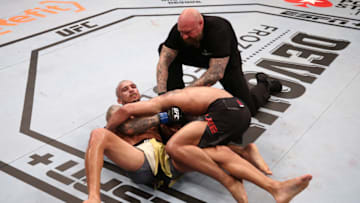 BRASILIA, BRAZIL - MARCH 14: (L-R) Charles Oliveira of Brazil secures a guillotine choke submission against Kevin Lee in their lightweight fight during the UFC Fight Night event on March 14, 2020 in Brasilia, Brazil. (Photo by Buda Mendes/Zuffa LLC)