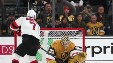Mar 3, 2023; Las Vegas, Nevada, USA; Vegas Golden Knights goaltender Adin Hill (33) makes a save against New Jersey Devils defenseman Dougie Hamilton (7) during a shoot out at T-Mobile Arena. Mandatory Credit: Stephen R. Sylvanie-USA TODAY Sports