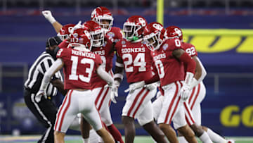 Dec 30, 2020; Arlington, TX, USA; Oklahoma Sooners linebacker Brian Asamoah (24) celebrates with teammates after an interception against the Florida Gators in the first quarter at ATT Stadium. Mandatory Credit: Tim Heitman-USA TODAY Sports
