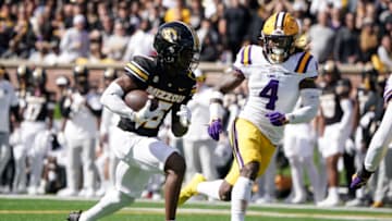 Oct 7, 2023; Columbia, Missouri, USA; Missouri Tigers wide receiver Daniel Blood (16) runs the ball as LSU Tigers linebacker Harold Perkins Jr. (4) defends during the first half at Faurot Field at Memorial Stadium. Mandatory Credit: Denny Medley-USA TODAY Sports