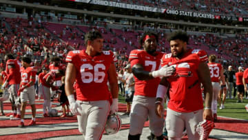Ohio State football players Ohio State Buckeyes offensive linemen Enokk Vimahi (66) and Donovan Jackson (74) walk with Ohio State Buckeyes defensive tackle Haskell Garrett (92) following a 66-17 win over the Maryland Terrapins in Saturday's NCAA Division I football game at Ohio Stadium in Columbus on October 9, 2021. Garrett left the game in the second half with an apparent injury but later returned to the sideline.Osu21mary Bjp 1686