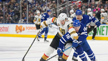 Nov 2, 2021; Toronto, Ontario, CAN; Toronto Maple Leafs forward Mitchell Marner (16) knocks the puck away from Vegas Golden Knights forward Mattias Janmark (26) during the first period at Scotiabank Arena. Mandatory Credit: John E. Sokolowski-USA TODAY Sports