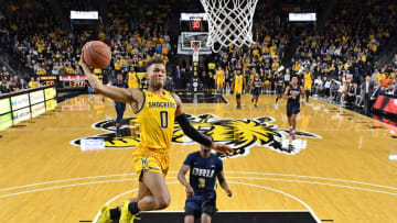 WICHITA, KS - NOVEMBER 23: Dexter Dennis #0 of the Wichita State Shockers drives to the basket for a dunk past Max Abmas #3 of the Oral Roberts Golden Eagles during the second half on November 23, 2019 at Charles Koch Arena in Wichita, Kansas. (Photo by Peter G. Aiken/Getty Images)