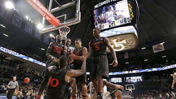 Feb 7, 2016; Atlanta, GA, USA; Miami (Fl) Hurricanes guard Sheldon McClellan (10) is helped up by his teammates after Georgia Tech Yellow Jackets guard Marcus Georges-Hunt (3, right) was called for an offensive foul against McClellan in the second half of their game at McCamish Pavilion. The Hurricanes won 75-68. Mandatory Credit: Jason Getz-USA TODAY Sports