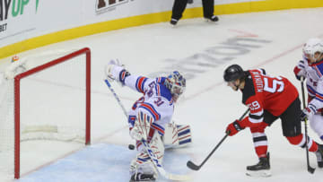 Mar 4, 2021; Newark, New Jersey, USA; New York Rangers goaltender Igor Shesterkin (31) makes a save on a shot by New Jersey Devils center Janne Kuokkanen (59) during the first period at Prudential Center. Mandatory Credit: Ed Mulholland-USA TODAY Sports