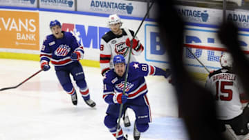 Amerks Brett Murray (81) and Peyton Krebs race to celebrate after Arttu Ruotsalainen scored the game-winner in OT to beat Utica 4-3.