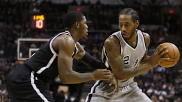 Nov 22, 2014; San Antonio, TX, USA; San Antonio Spurs small forward Kawhi Leonard (2) holds the ball as Brooklyn Nets small forward Joe Johnson (L) defends during the first half at AT&T Center. Mandatory Credit: Soobum Im-USA TODAY Sports