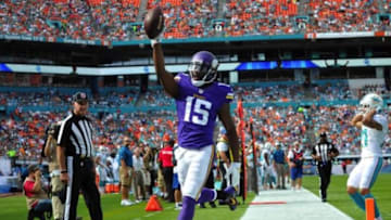 Dec 21, 2014; Miami Gardens, FL, USA; Minnesota Vikings wide receiver Greg Jennings (15) scores a touchdown as Miami Dolphins cornerback Brent Grimes (21) reacts during the first half at Sun Life Stadium. Mandatory Credit: Steve Mitchell-USA TODAY Sports