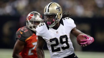 NEW ORLEANS, LA - OCTOBER 05: Khiry Robinson #29 of the New Orleans Saints avoids a tackle by Alterraun Verner #21 of the Tampa Bay Buccaneers during the first quarter of a game at the Mercedes-Benz Superdome on October 5, 2014 in New Orleans, Louisiana. (Photo by Chris Graythen/Getty Images)