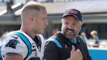Sep 12, 2021; Charlotte, North Carolina, USA; Carolina Panthers head coach Matt Rhule talks with running back Christian McCaffrey (22) after the second half at Bank of America Stadium. Mandatory Credit: Jim Dedmon-USA TODAY Sports