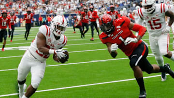 HOUSTON, TX - SEPTEMBER 01: Scottie Phillips #22 of the Mississippi Rebels scores in the second quarter as Jordyn Brooks #1 of the Texas Tech Red Raiders attempts to keep him out ot the endzone at NRG Stadium on September 1, 2018 in Houston, Texas. (Photo by Bob Levey/Getty Images)